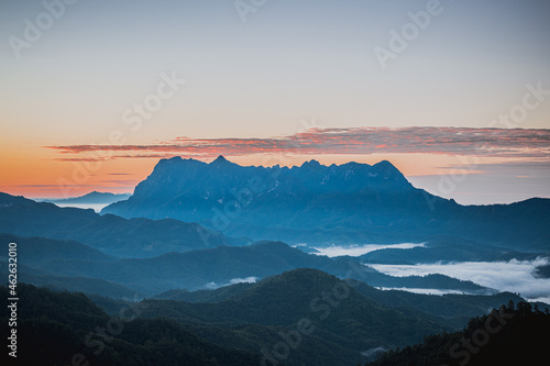 Scenery of the sky gradient from blue to orange sunrise over the valley at Doi Luang  Chiang Dao  Chiang Mai  Thailand.