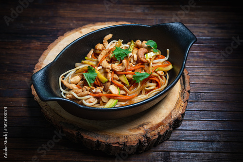 Asian style- restaurant background. Udon noodles with beef Wok