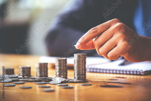 Holding the money saving coin, place the coin on the sunlit table. Finance and Accounting Concepts