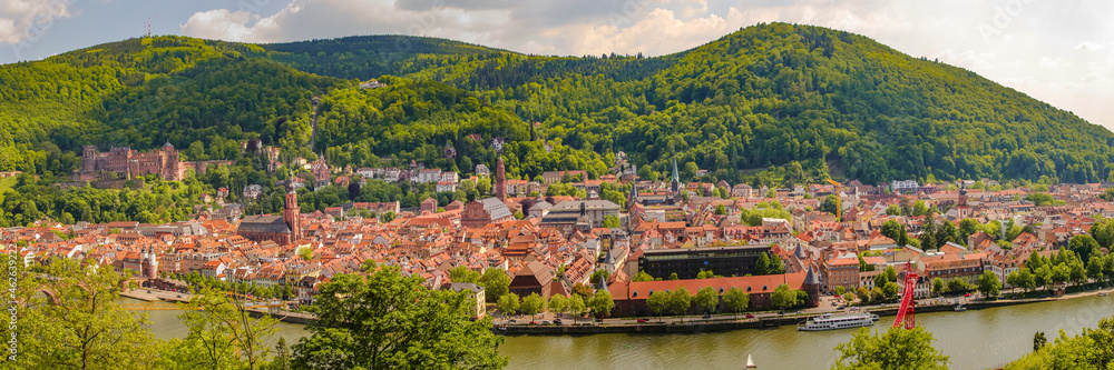 Panoramic bird view over old historical downtown, Neckar river and forests at hills in Heidelberg at sunny summer day.