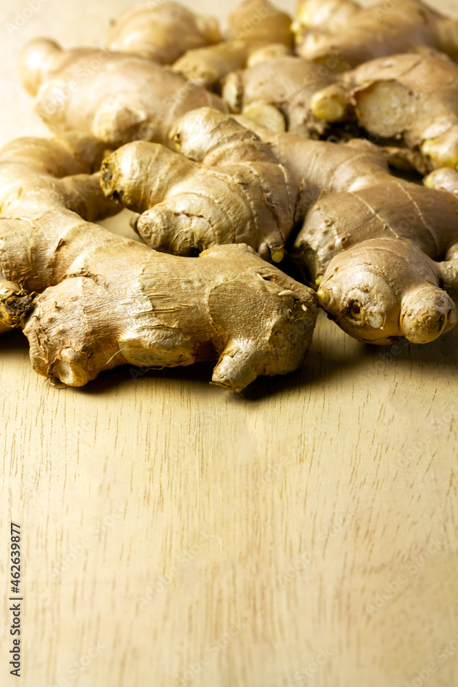 Fototapeta premium Fresh ginger on rustic wooden background. Ginger is a food and herb for healthcare.
