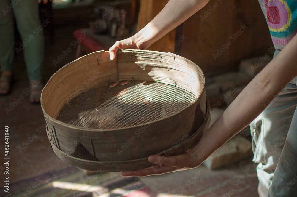 Old sieves, tool for bakery from the past for flour sifting in female hands Old sieves, tool for bakery from the past for flour sifting in female hands
