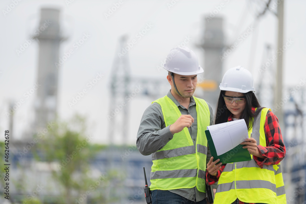 Fototapeta premium Two engineer working at power plant,Work together happily,Help each other analyze the problem,Consult about development guidelines