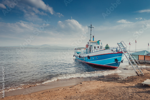 Ferryboat ship is waiting for tourists on the shore of Lake Sevan in Armenia. Water tours and cruises