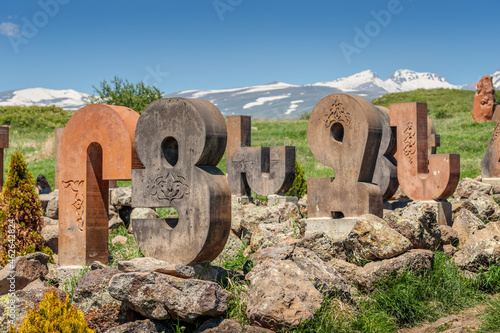Armenian alphabet monument with stone sculptures of letters and Mesrop Mashtots photo