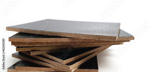 close up stack of black melamine samples showing wooden edge isolated on white paper background with clipping path. melamine panels, MDF wooden board, samples. photo