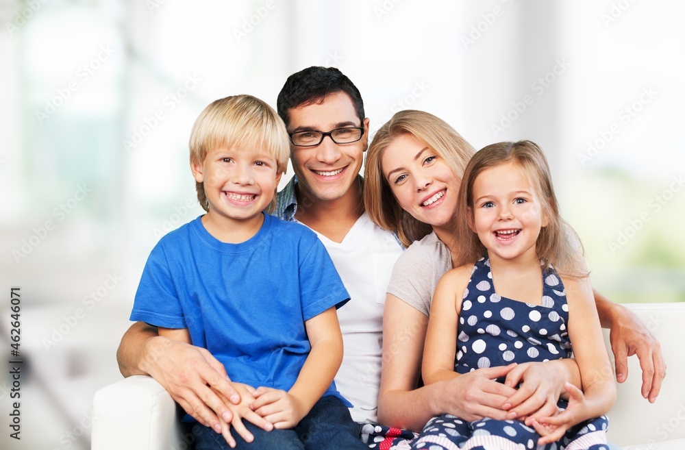 Happy family greeting to the camera. Children, father and mother smiling Happy family greeting to the camera. Children, father and mother smiling