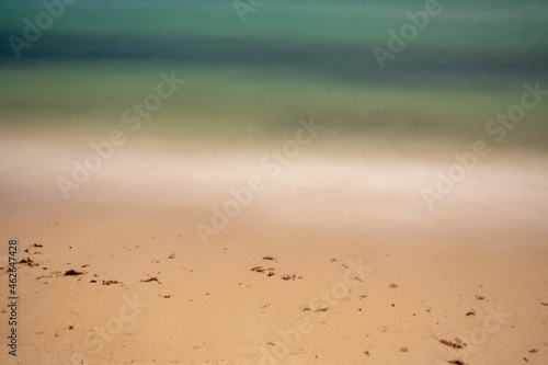 Long exposure ocean waves on sandy shores