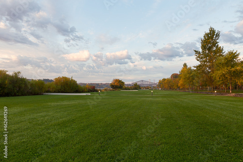 Park along the Samuel-de-Champlain boulevard seen during a beautiful autumn dawn, with the Quebec Bridge in soft focus background, Sillery area, Quebec City, Quebec, Canada photo