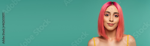 pretty young woman with pink dyed hair smiling isolated on blue  banner