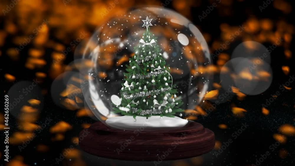 Shooting star around christmas tree in a snow globe over orange falling against black background Shooting star around christmas tree in a snow globe over orange falling against black background
