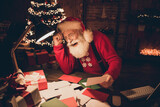 Photo portrait santa with white beard wearing glasses reading wishlist before xmas laughing overjoyed