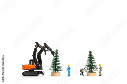 Miniature people, Worker Preparing Christmas tree on white background , Christmas and Happy New Year concept.