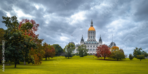 Dramatic cloudscape and autumn landscape over Connecticut State Capital building in Bushnell Park in Hartford, Connecticut photo