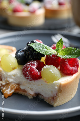 Delicious tartlet with berries on plate, closeup