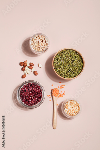 Vegan protein source. Beans, peas, chickpeas, lentils, mung bean, peanut in bowl on beige background. photo