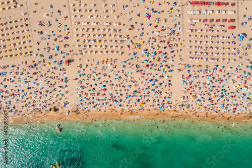 Obraz na płótnie Drone shot of many people enjoying the beach and the ocean in high season- vacation pattern. w salonie