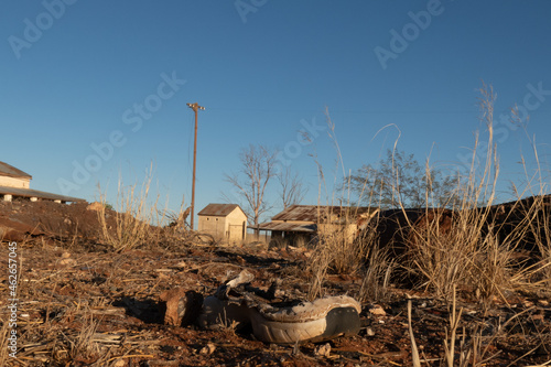 Remains of a old shoe which and the old derelict buildings at the abandoned railway town called Putsonderwater, ghost town in South Africa. photo