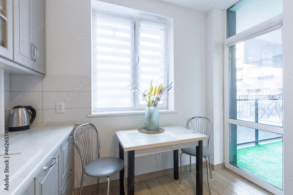 Fototapeta premium Interior of a modern beige and gray kitchen in a small smart apartment