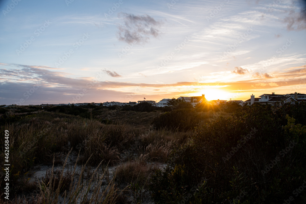 Sunset behind the dunes and beach houses