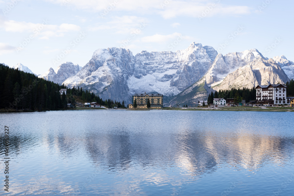 Reflection of the snowy mountain in the Misurina lake, in Dolomites, Italy.