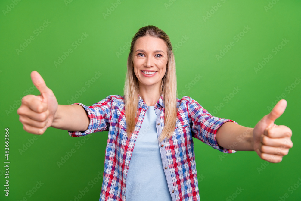 Photo of young excited woman happy positive smile show thumb-up recommend ad isolated over green color background Photo of young excited woman happy positive smile show thumb-up recommend ad isolated over green color background