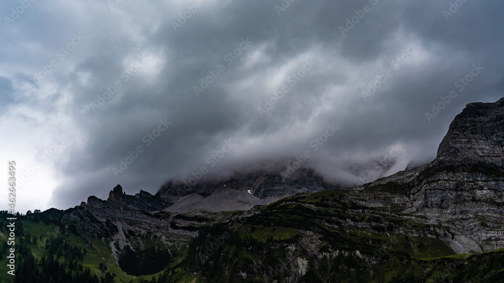 Mountain peak which is surrounded by clouds