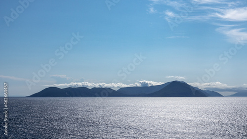 Wallpaper Mural Blue Ionian sea landscape view on Lefkada Greece island. Bright day with low clouds over distant islands and contrast sunbeam on water Torontodigital.ca