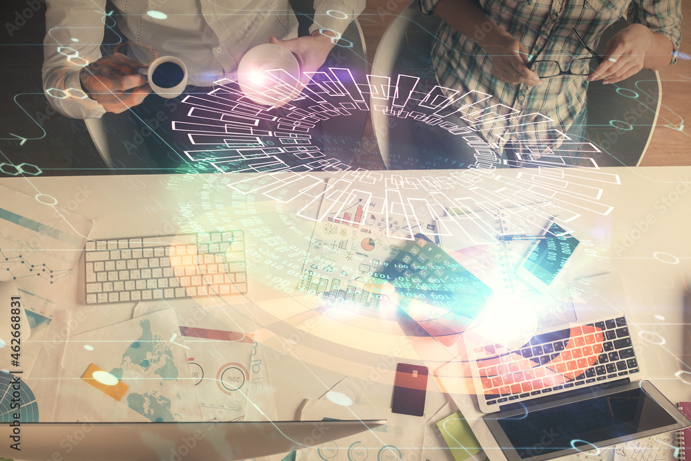 Fototapeta premium Double exposure of man and woman working together and data theme hologram drawing. Computer background. Top View.