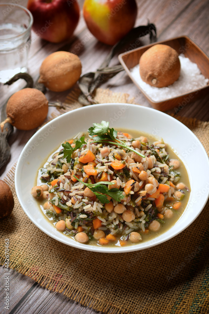 Brown rice soup with chickpeas, spinach and carrots - closeup Brown rice soup with chickpeas, spinach and carrots - closeup