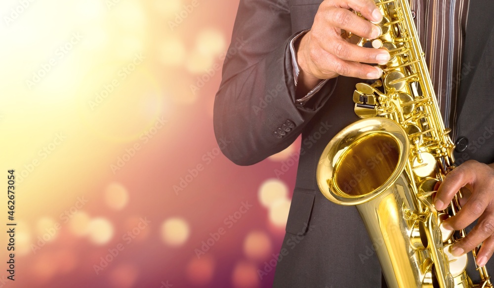 Obraz premium Beautiful golden saxophone on bokeh background,