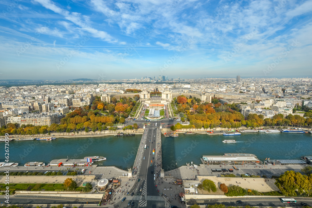 View from the first platform of the Eiffel Tower featuring the River Seine and the Trocadero Gardens as fall leaves start to turn colors in Autumn, in Paris, France.