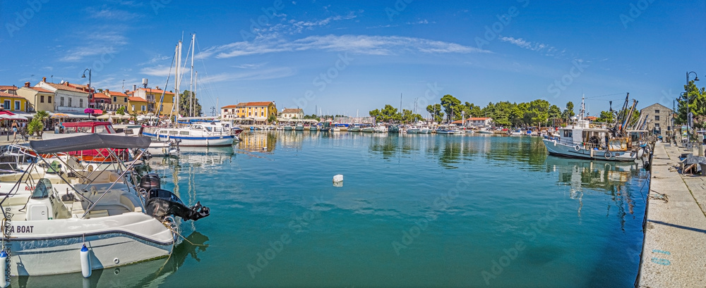 Panoramic view over the harbor of the Croatian coastal town of Novigrad in Istria during the day when the weather is clear