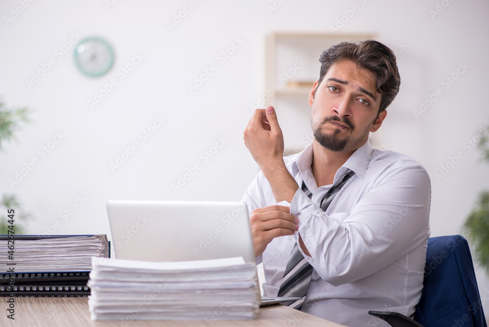 Young male employee working in the office Young male employee working in the office