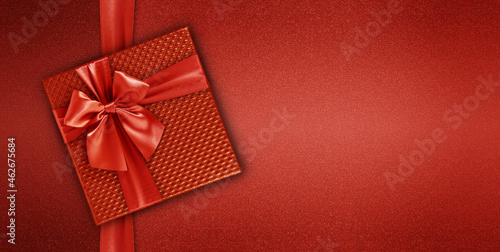 merry christmas gift card with gift red box with ribbon and bow  isolated on red background  top view and copy space template  layout useful for best wishes or valentine shopping concept