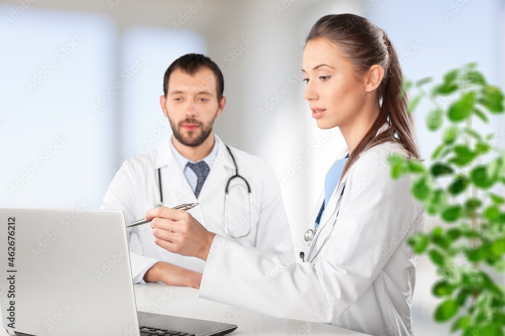 Doctor talking to an online patient on laptop screen sitting at clinic office, online consultation Doctor talking to an online patient on laptop screen sitting at clinic office, online consultation