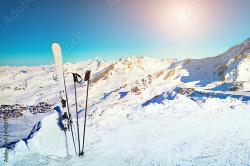 Winter ski resort in Alps mountains. Ski equipment in the snow on the slope. Val Thorens, 3 Valleys, France. Snow-covered mountains and the blue sky © smallredgirl
