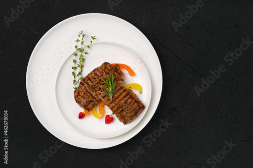 Two grilled steaks on a plate