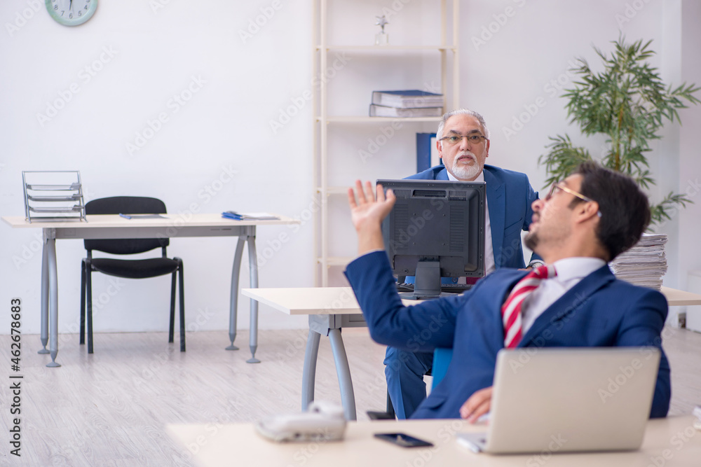 Two male colleagues working in the office Two male colleagues working in the office