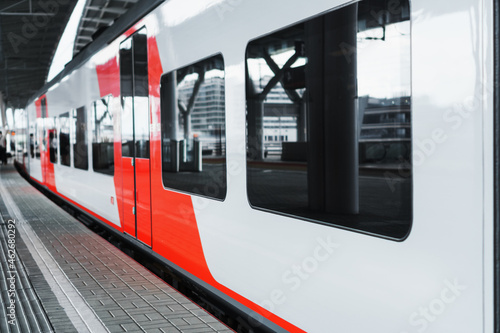 A modern high-speed electric train stands on a platform.