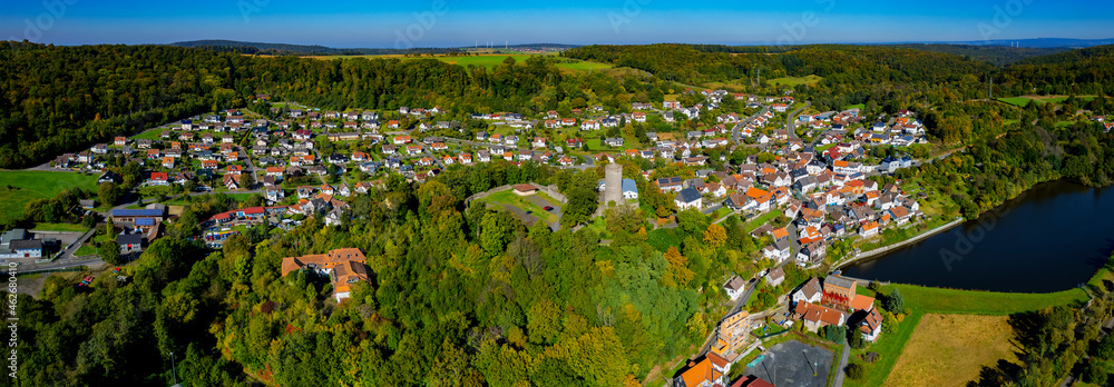 Aerial around the village Lißberg in Germany, hesse on a sunny  late summer day.