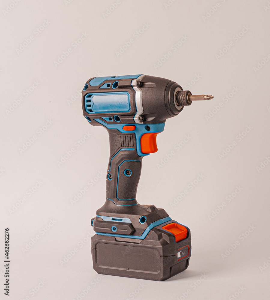 Cordless electric screwdriver with a power tip isolated on a light background