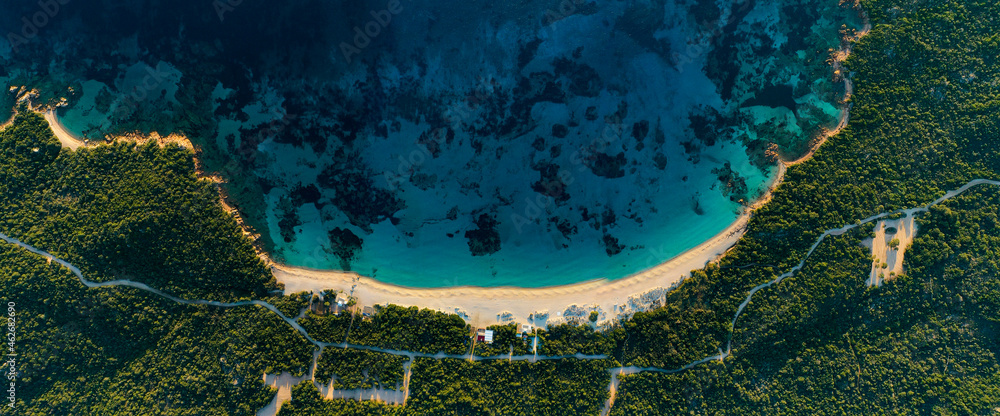 View from above, stunning aerial view of a white sand beach bathed by a turquoise water. Long Beach, Liscia Ruja, Sardinia, Italy.