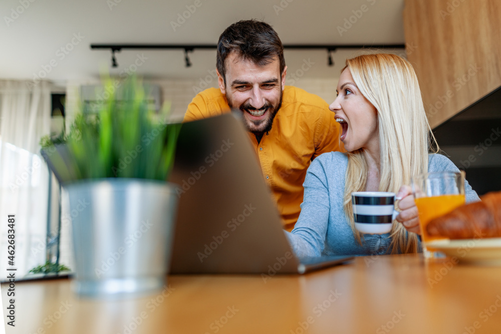 Couple working together at small office with laptop Couple working together at small office with laptop