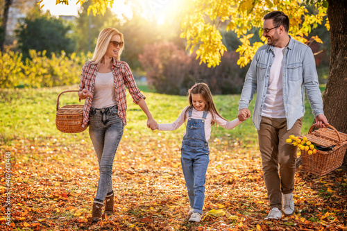 Happy family having picnic in park on sunny summer day