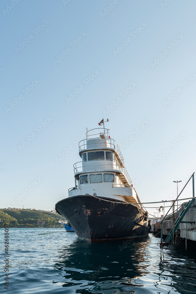 Fishing boat moored to a concrete pier on the coast of the Bosphorus channel