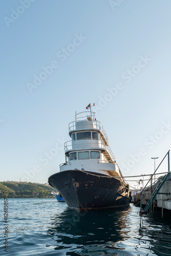 Fishing boat moored to a concrete pier on the coast of the Bosphorus channel © Toyakisfoto.photos