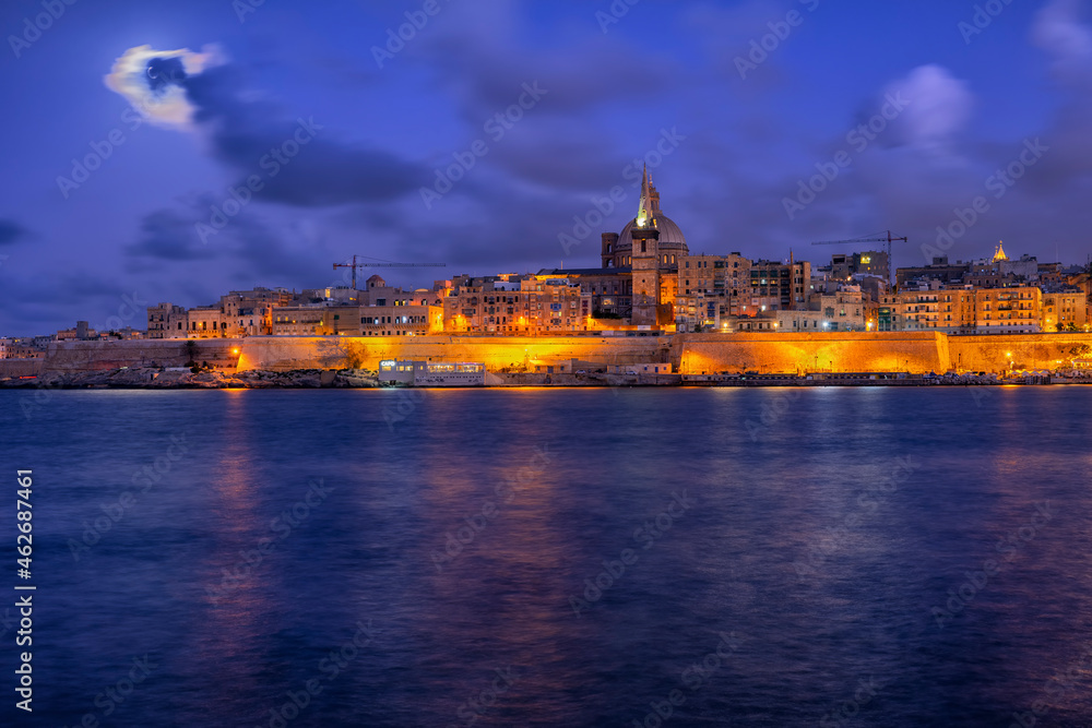 Malta, Valletta, View of city illuminated at night across water Malta, Valletta, View of city illuminated at night across water