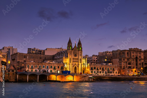 Malta, St. Julian, Town skyline at night with Carmelite Church at Balluta Bay photo