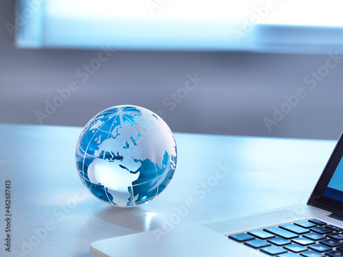 Global Markets, A glass globe with a laptop photo